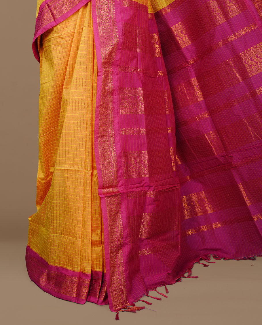 Yellow colour kalyani cotton saree featuring gold zari check pattern on body, complemented by Magenta colour with Antique zari border, paired with matching blouse piece.