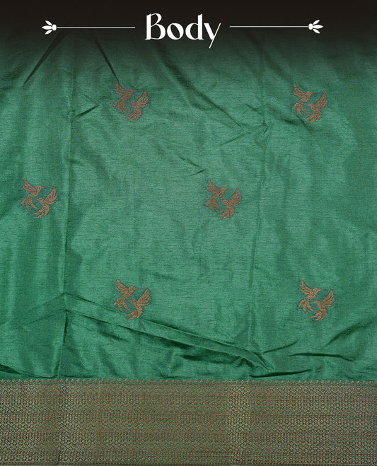 Green colour semi banaras tussar silk saree highlighting gold zari bird motifs on body, complemented by self colour with antique zari border, paired with matching blouse piece.