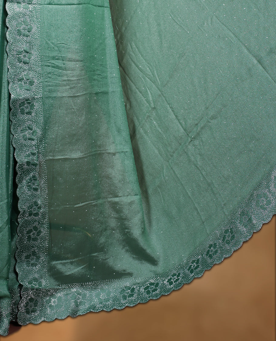 Pastel green colour shimmer designer saree, featuring white scattered stone on body, stone work and heavy stone floral pattern on border and  pallu, Paired with matching blouse.