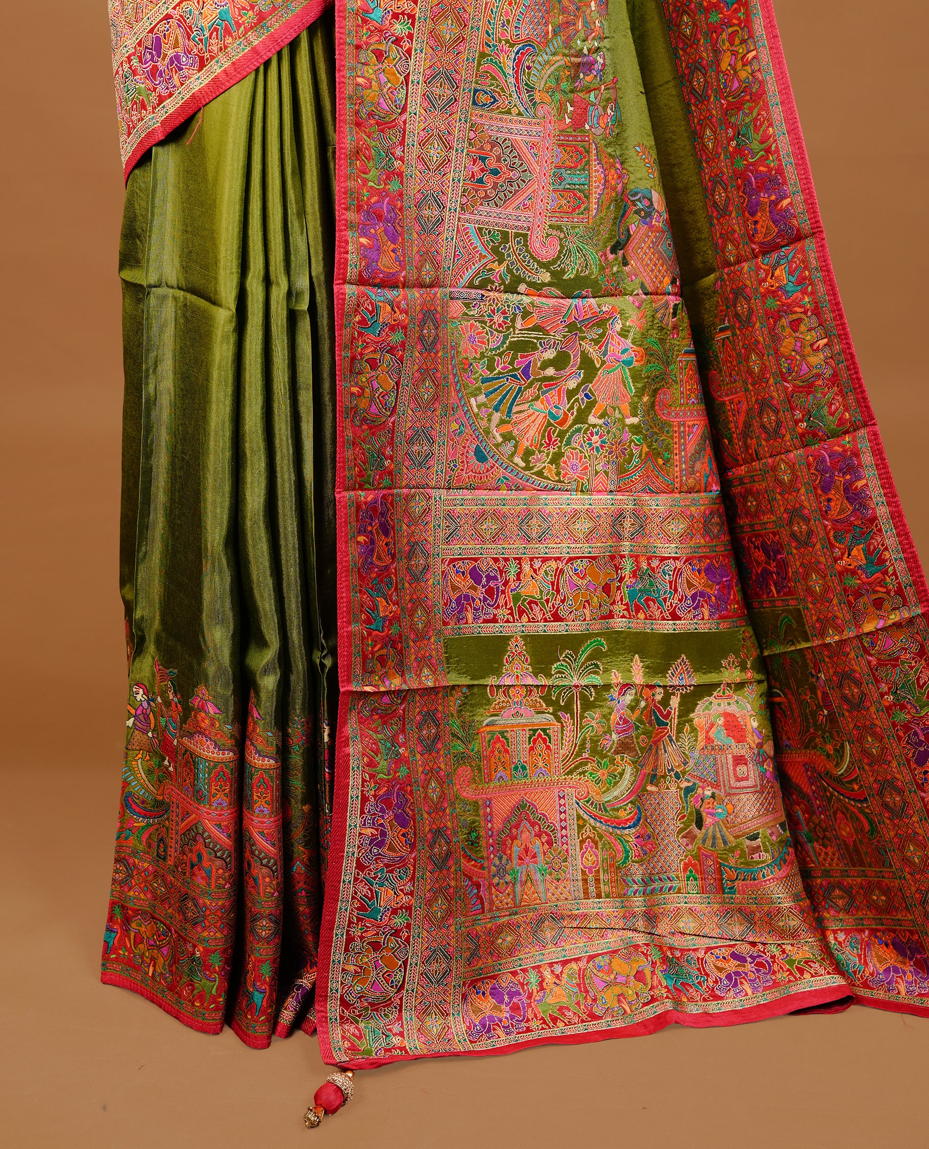 Olive green colour Pashmina Saree featuring Plain body, a contrast multicolour Temple & Paisley woven motifs border with red edging, an ornate paisley woven pallu, paired with a matching blouse.