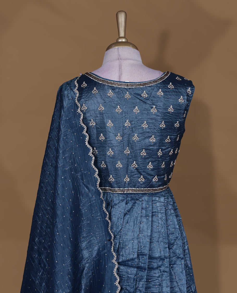 Midnight blue colour stitched gown set with sleeveless embroidered yoke, flared ankle‑length silhouette, and attached dupatta featuring dainty butti work and scalloped beaded edging.