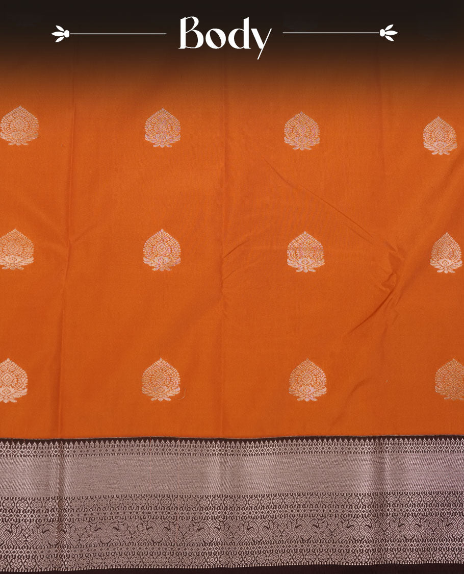 Rust orange colour semi silk saree featuring gold zari floral  motifs on body highlighting contrast dark chocolate rose gold zari peacock border , paired with matching blouse