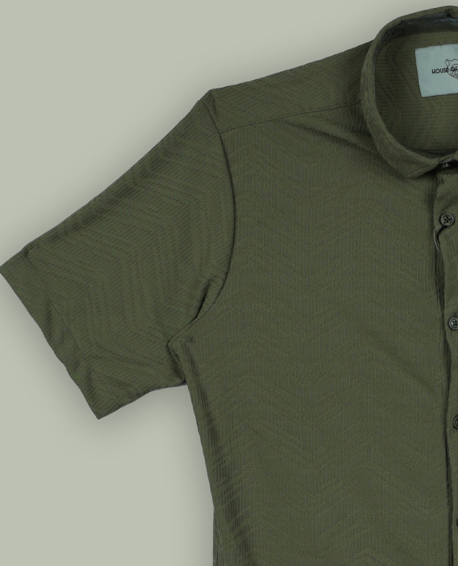 Pastel olive green colour textured shirt featuring a subtle chevron pattern, classic collar, and short sleeves & Crafted for effortless comfort and style.