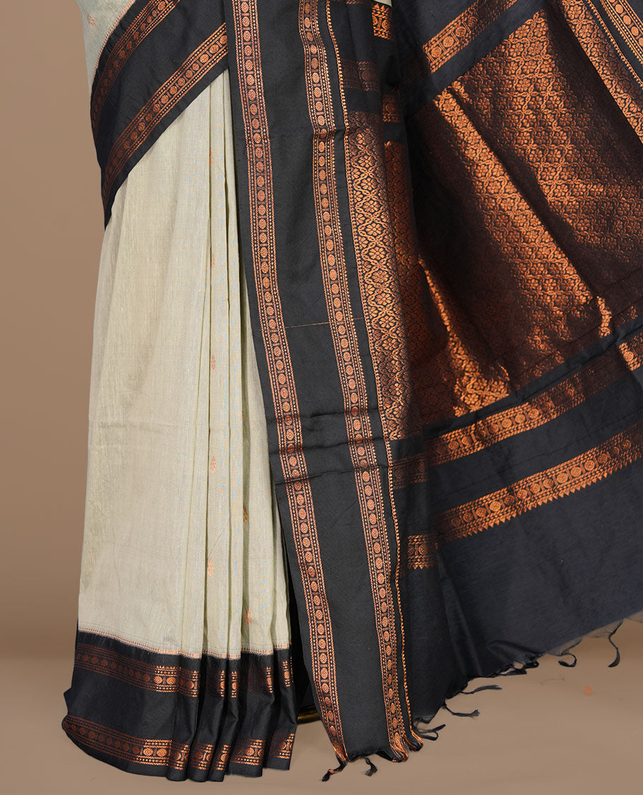 Grey colour kalyani cotton saree featuring gold zari motifs on body, complemented by contrast Black color with copper zari pattern border , paired with matching blouse piece.