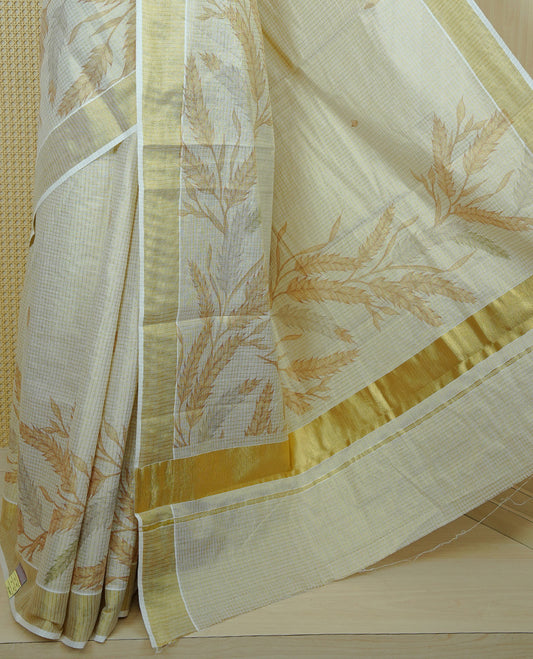Light gold colour tissue Kerala saree featuring Leaf print & Gold zari check on body, complemented by gold Border, comes with matching blouse piece.
