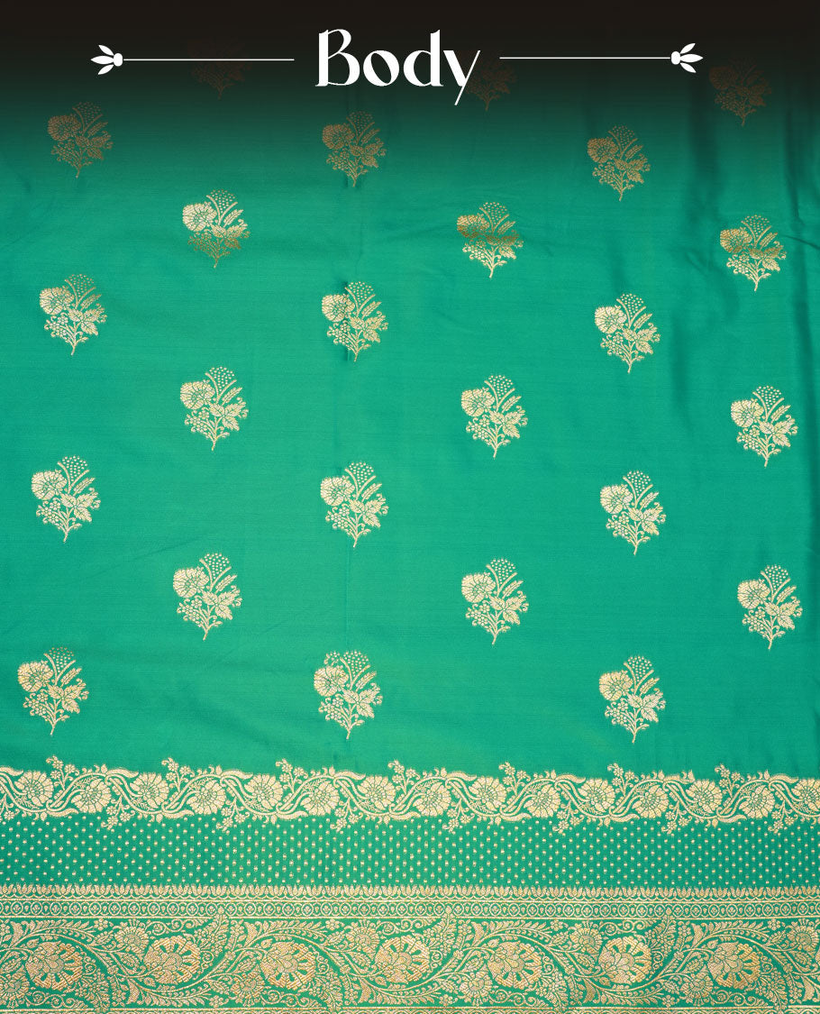 Green colour Banaras Satin Crepe saree featuring gold zari floral motifs on the body, a richly woven traditional border with intricate gold zari detailing, and paired with a matching blouse.