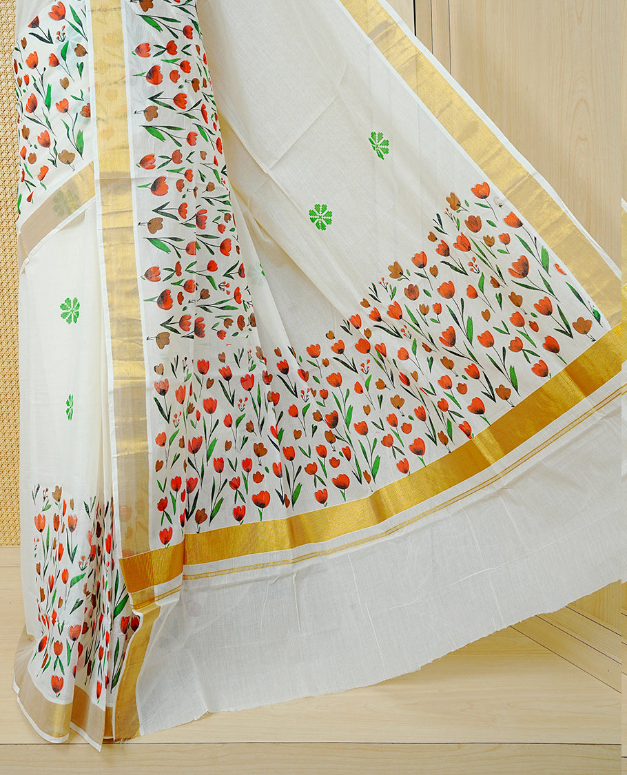 Cream Colour Cotton Kerala Saree Featuring Digital Red & Brown Colour Floral  Motifs On Body, With A Classic Gold Zari Border & A Gold Zari Pallu, Paired With A Matching Blouse Piece.