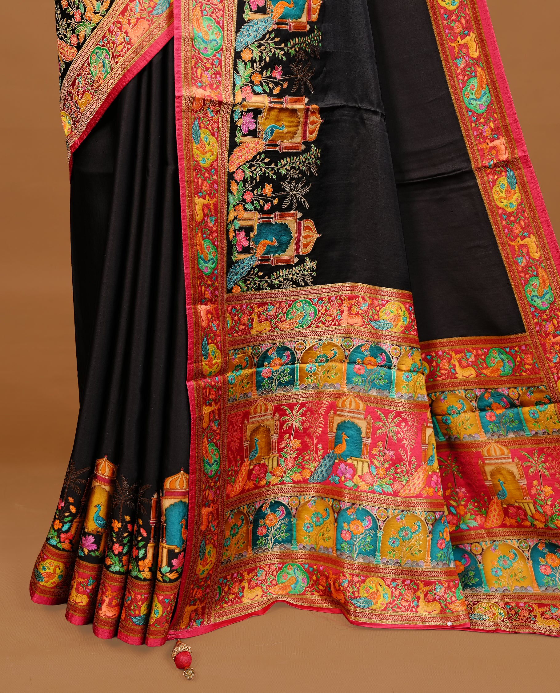 Black colour Pashmina Saree featuring elegant woven temple motifs, enhanced with a contrast pink woven border and a richly detailed traditional pallu, paired with a matching blouse piece.
