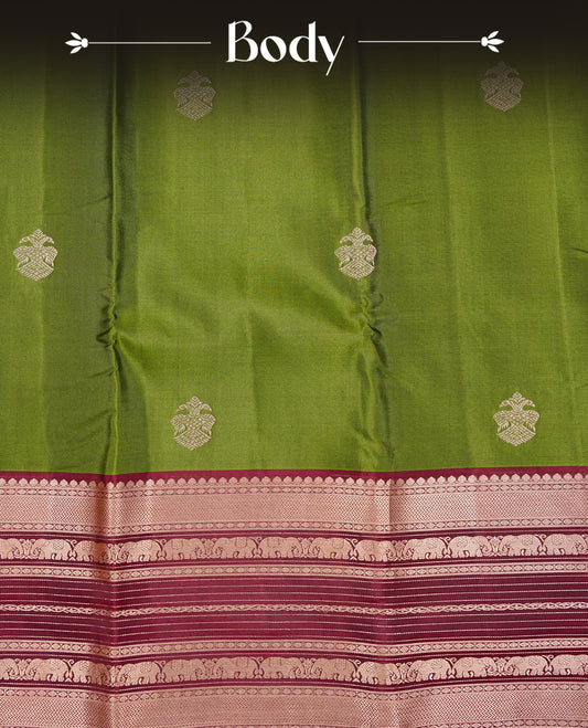 Olive Green Colour Kancheepuram silk saree featuring gold zari motifs on body, highlighting Gold zari Elephant Traditional On contrast Maroon border, paired with Matching blouse piece.