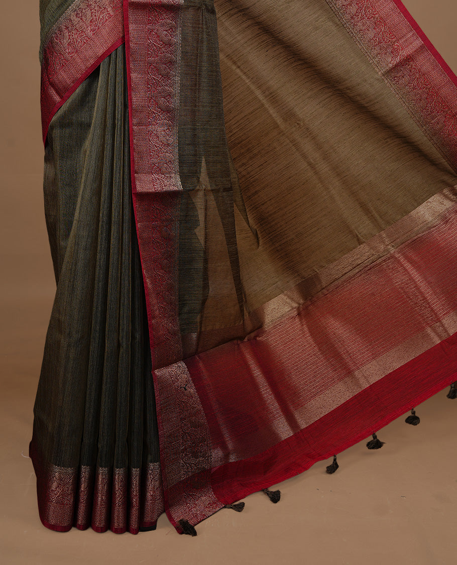 Bronze Olive colour Semi linen saree featuring Elegant plain body, complemented by contrast Green colour With Antique zari border, paired with matching blouse piece.