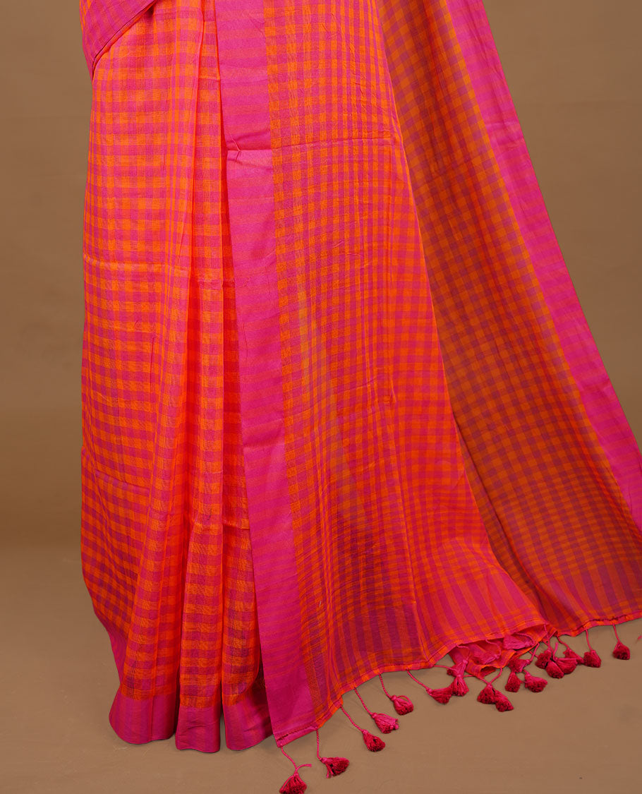 Orange and Pink colour Mul Cotton saree featuring a classic Big check pattern on the body, accented with tassels for added charm. Comes without a blouse piece.