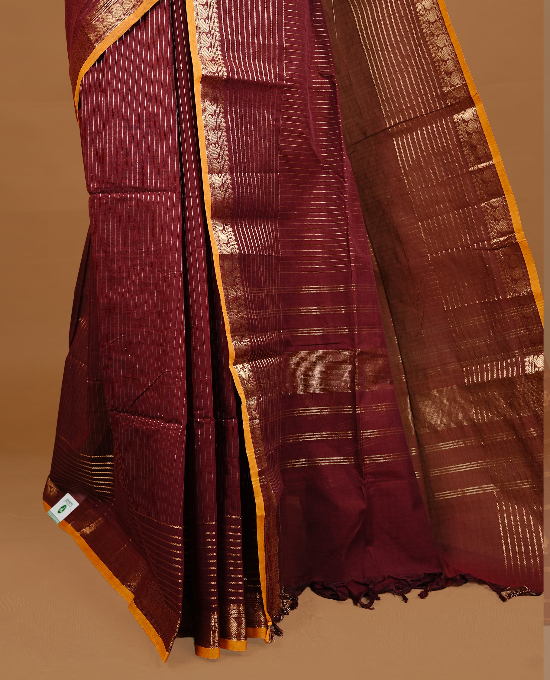 Maroon colour Chettinad cotton saree featuring gold zari stripes on body , complemented by contrast Magenta colour with zari border, comes with matching blouse piece.