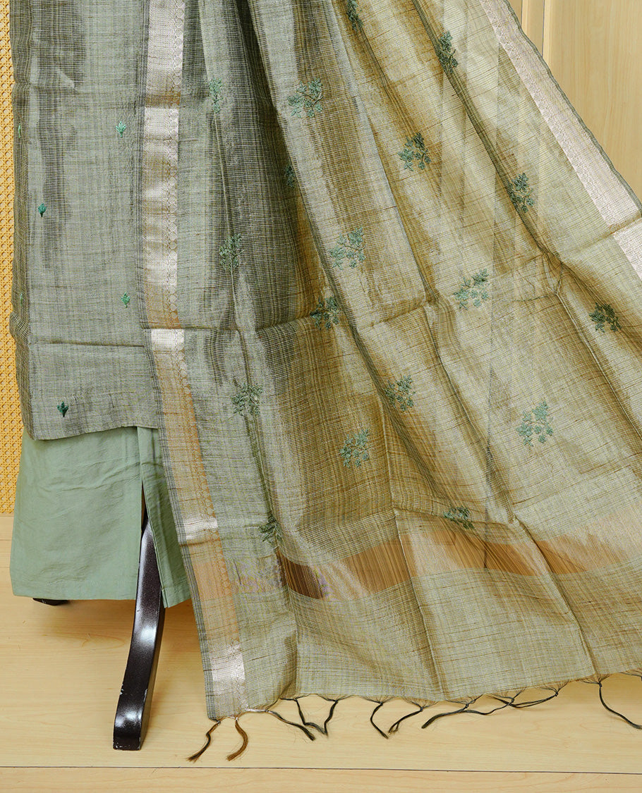 Green colour Tissue Churidar Set featuring delicate floral embroidery and subtle sequin detailing on the yoke, paired with matching solid pants and dupatta.