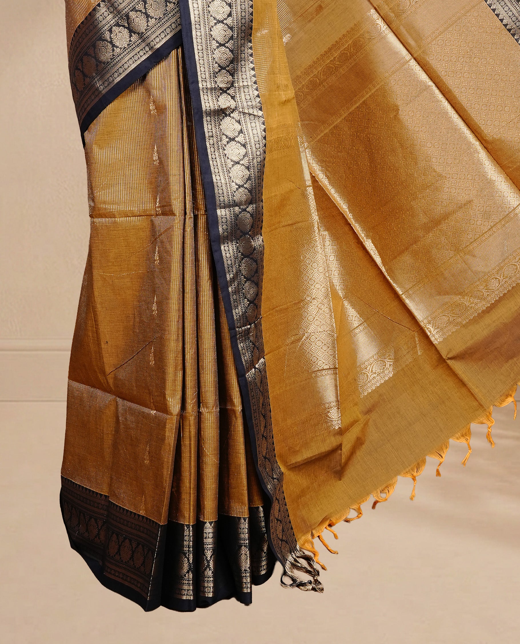 Mustard colour chettinad cotton saree featuring gold zari stripes & motifs on body, complemented by Contrast Black colour with zari border, paired with matching blouse piece.