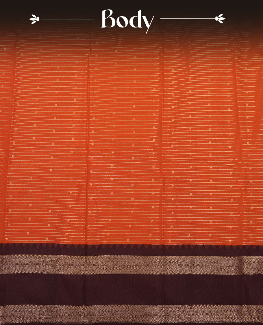 Rust orange colour semi silk saree featuring gold zari stripes small motifs on body highlighting contrast dark chocolate gold zari floral chakra border , paired with matching blouse