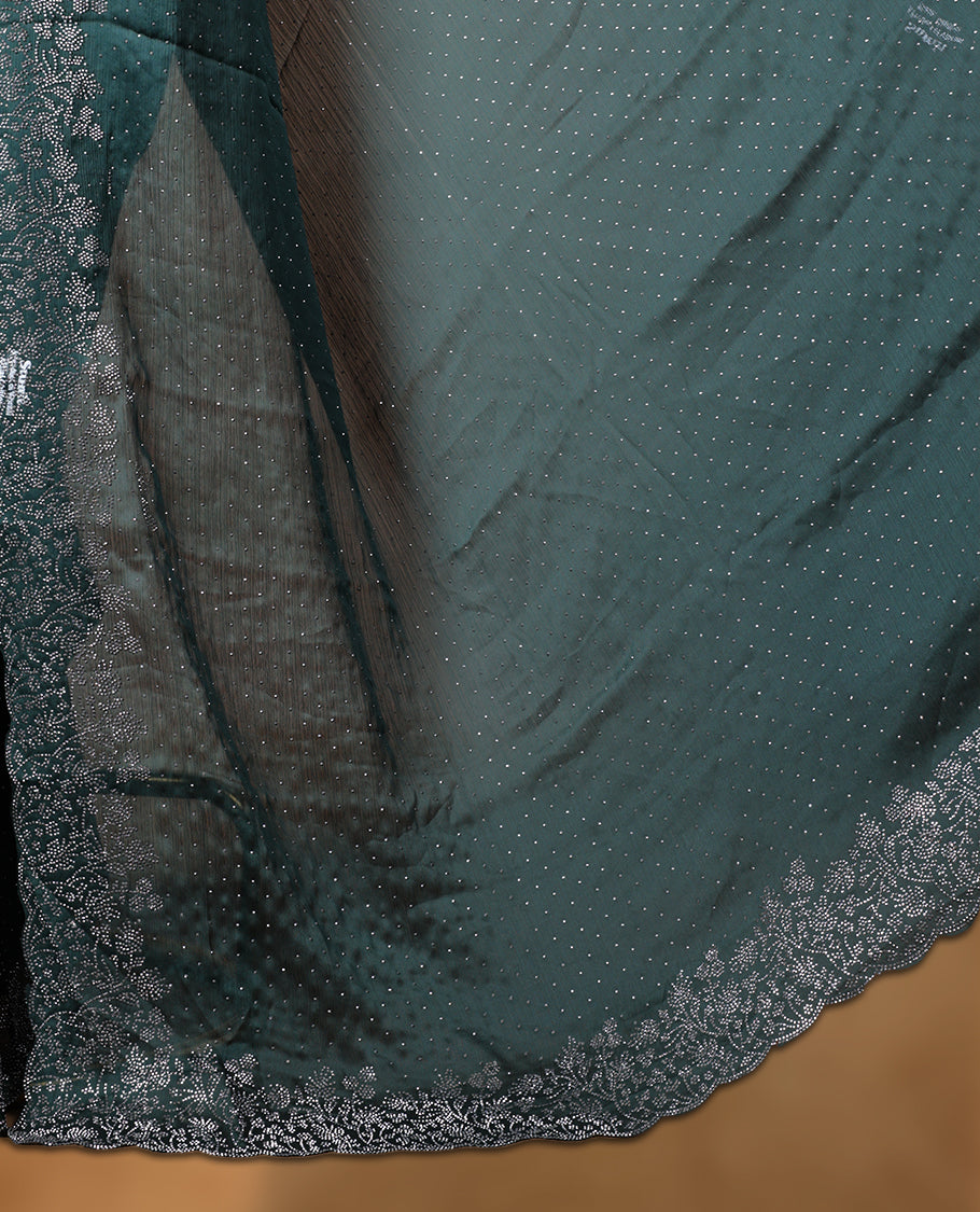 Dark green colour shimmer designer saree, featuring white scattered stone on body, stone work and heavy stone floral pattern on border and  pallu, Paired with matching blouse.