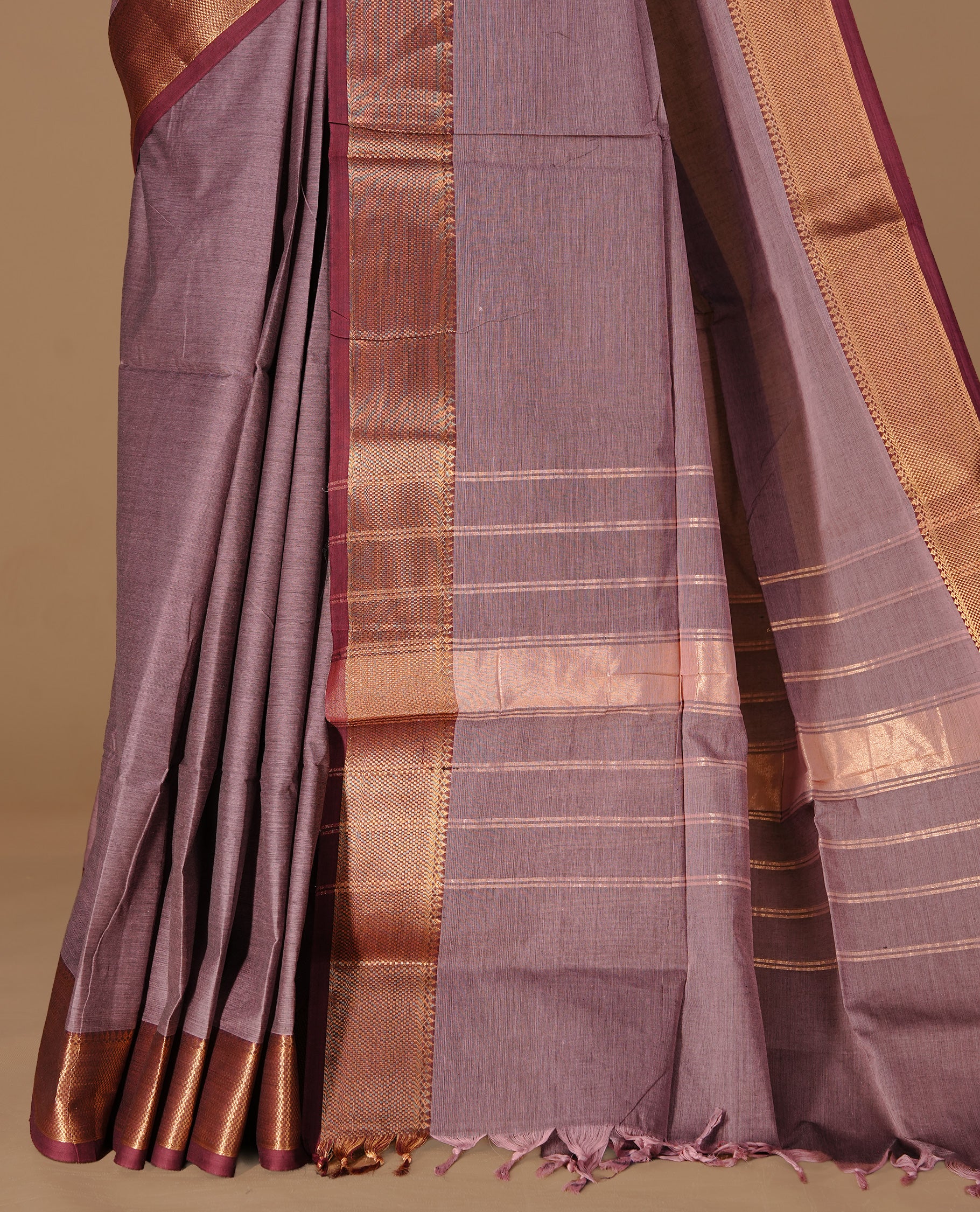 Bronze colour Chettinad Cotton saree featuring elegant plain body, complemented by contrast maroon colour with gold zari border, paired with matching blouse piece.