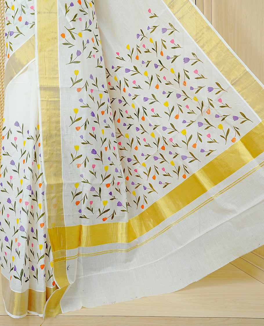 Cream Colour Cotton Kerala Saree Featuring Digital Floral  Motifs On Body, With A Classic Gold Zari Border & A Gold Zari Pallu, Paired With A Matching Blouse Piece.