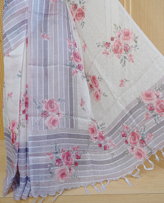 Cream colour semi linen saree featuring Red colour floral print on body, complemented by contrast Strip pattern border, comes with matching blouse piece.