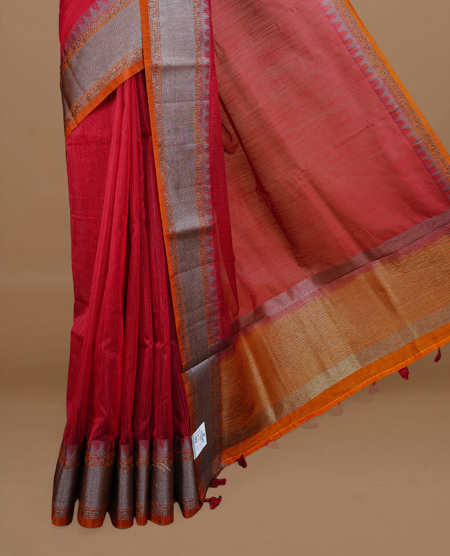 Red colour Semi linen saree featuring Elegant plain body, complemented by contrast Orange colour With Antique zari border, paired with matching blouse piece.