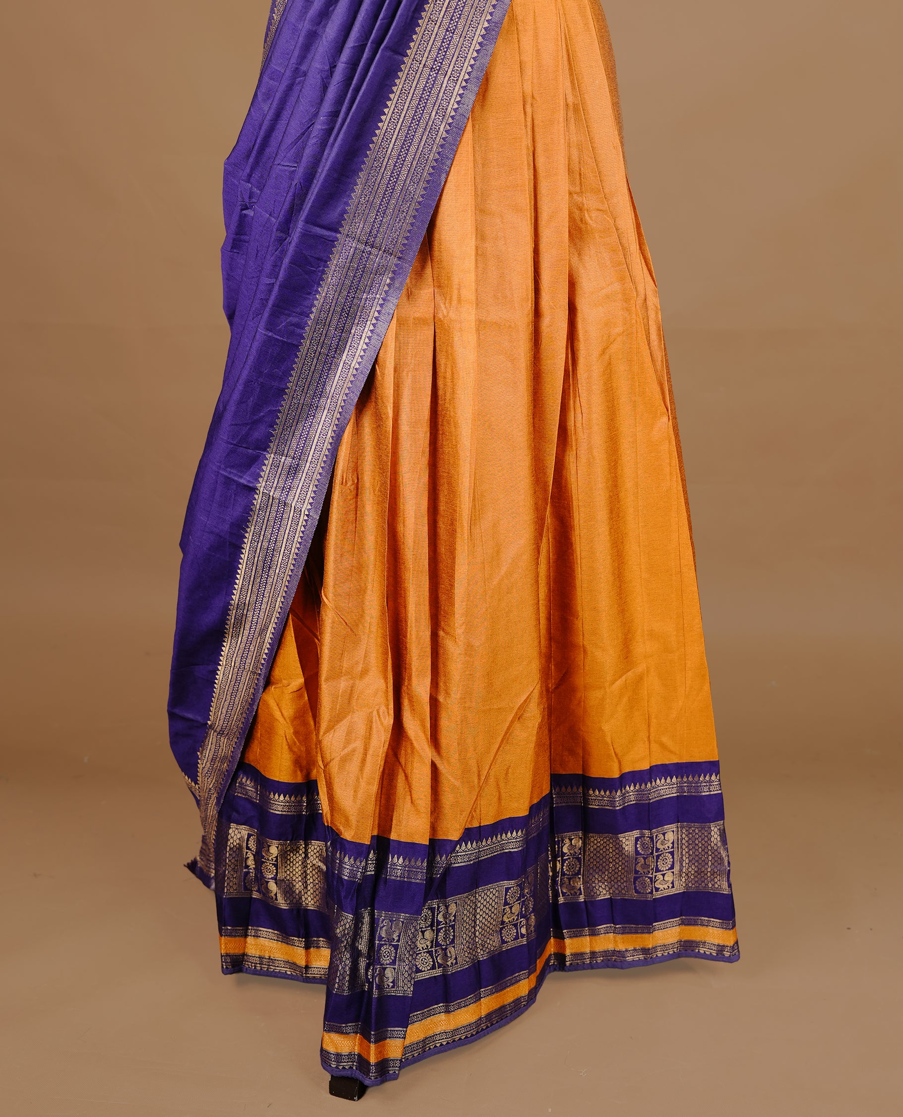 Mustard colour semi stitched Half saree featuring contrast navy blue colour with gold zari traditional border skirt, paired with matching zari border dupatta, unstitched blouse piece