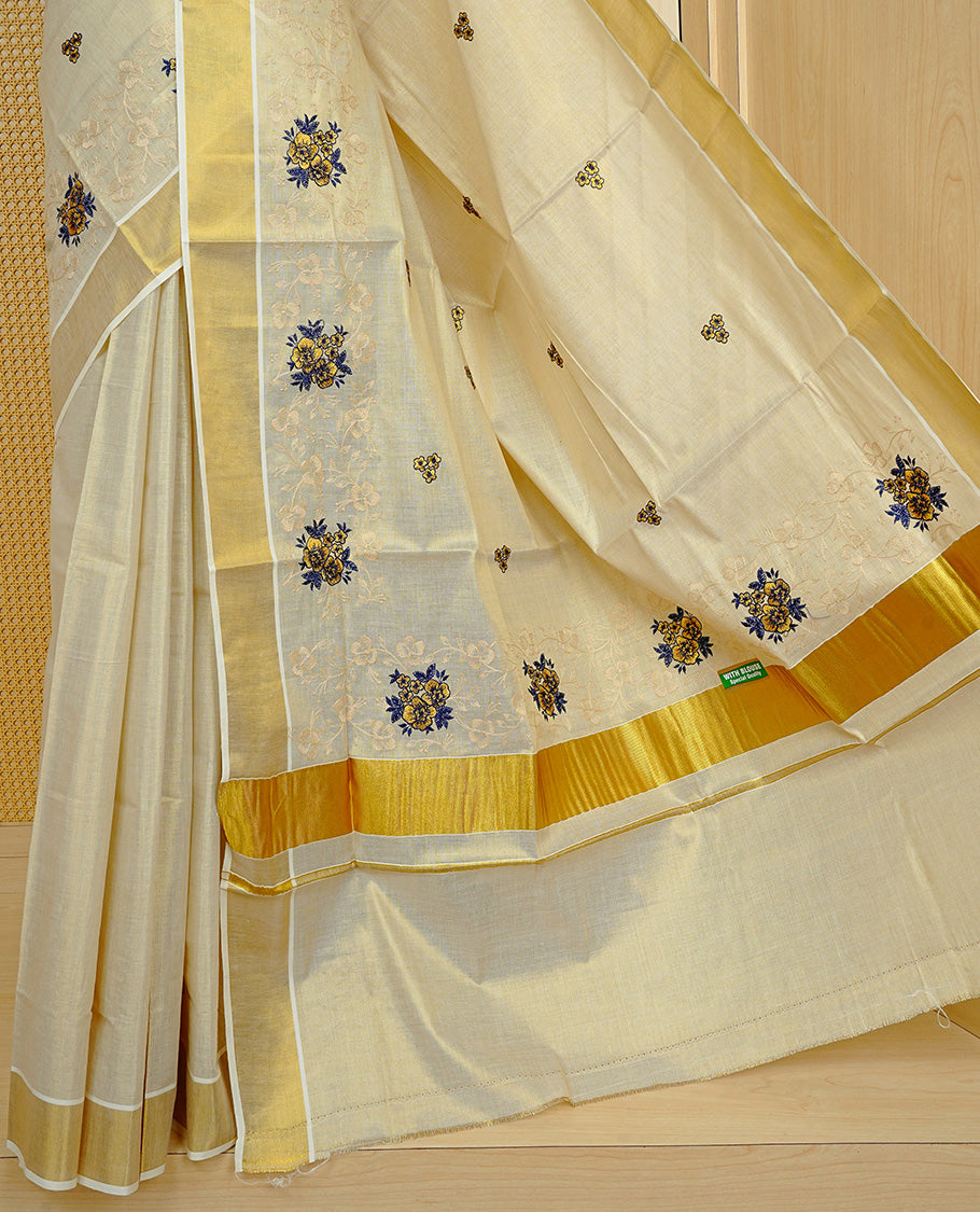 Cream colour Tissue kerala saree featuring Embroidery buttas on body, complemented by Floral kodi thread work & kasavu kara, comes with matching blouse piece.