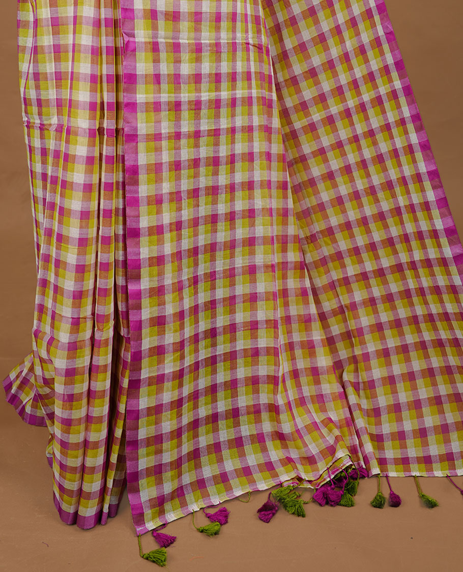 Green, Purple and White colour Mul Cotton saree featuring a classic Big check pattern on the body, accented with tassels for added charm. Comes without a blouse piece.
