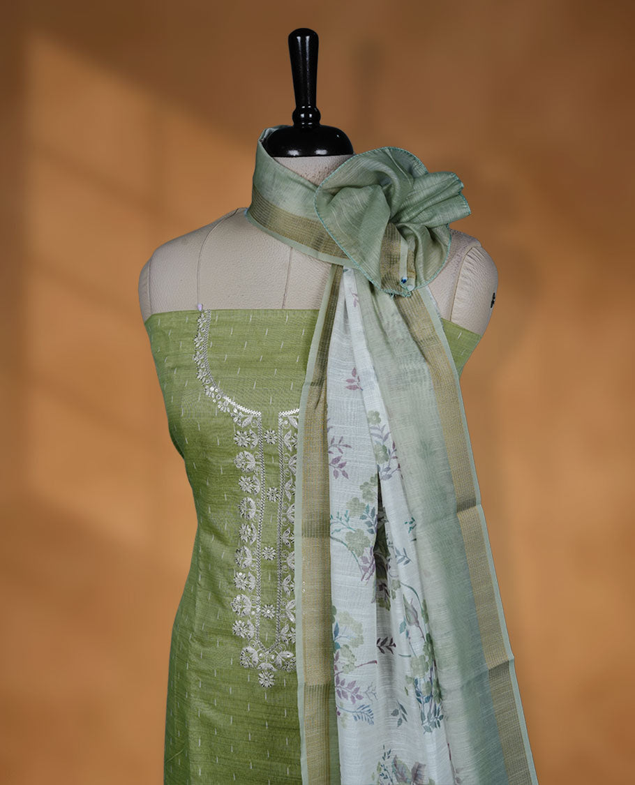 Pista green colour semi chanderi salwar material small strip thread work on the body, sequence on neckline and dupatta floral print and small gold border, paired with a plain bottom.