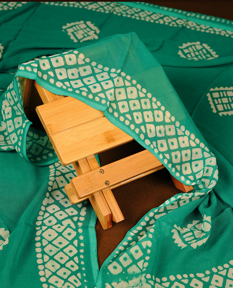 Mint green colour churidar material featuring elegant gold butta work on the front panel, paired with a printed dupatta and matching bottom.