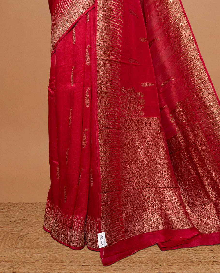 Red colour Semi Banaras Tussar Georgette Featuring Gold zari Leaf pattern on body, Finished with Gold zari border and paired with matching blouse piece.