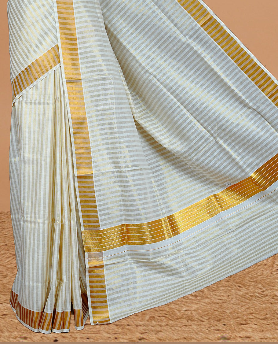 Cream colour Kerala saree featuring Gold zari Stripped body, enrich by Classy zari Border, pallu ,comes with matching blouse piece.