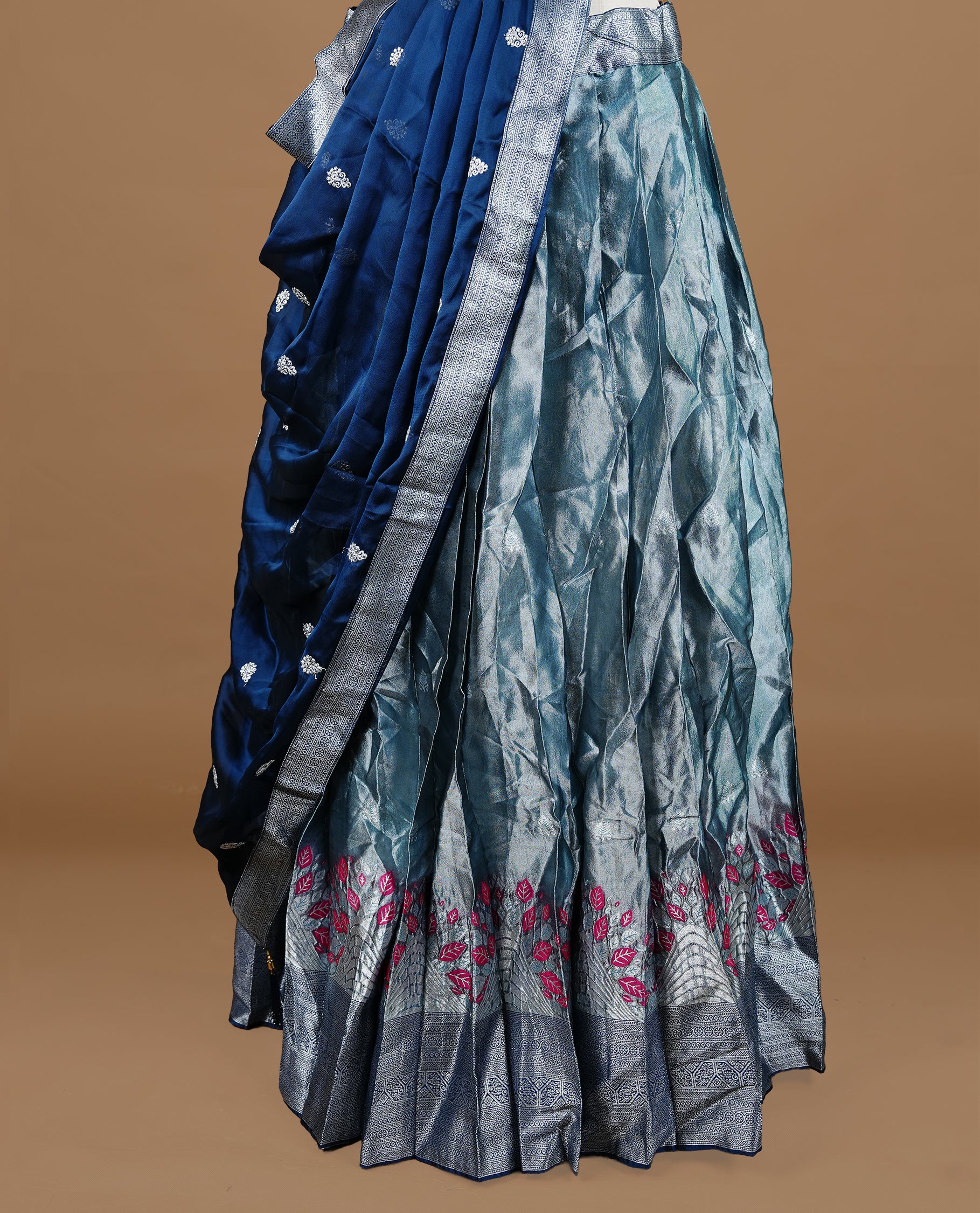 Bluish silver colour Half saree featuring Bluish silver skirt with contrast dark blue colour with silver zari traditional with floral pattern border, paired with matching dupatta, stitched blouse piece.