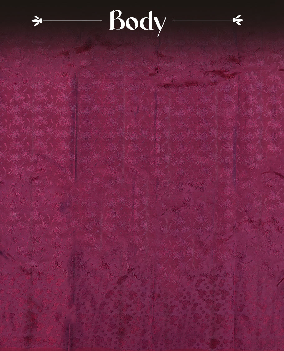 Wine colour semi soft silk saree featuring a self coloured textured patterned body, complemented by self coloured motifes on pallu & border and a matching blouse piece.