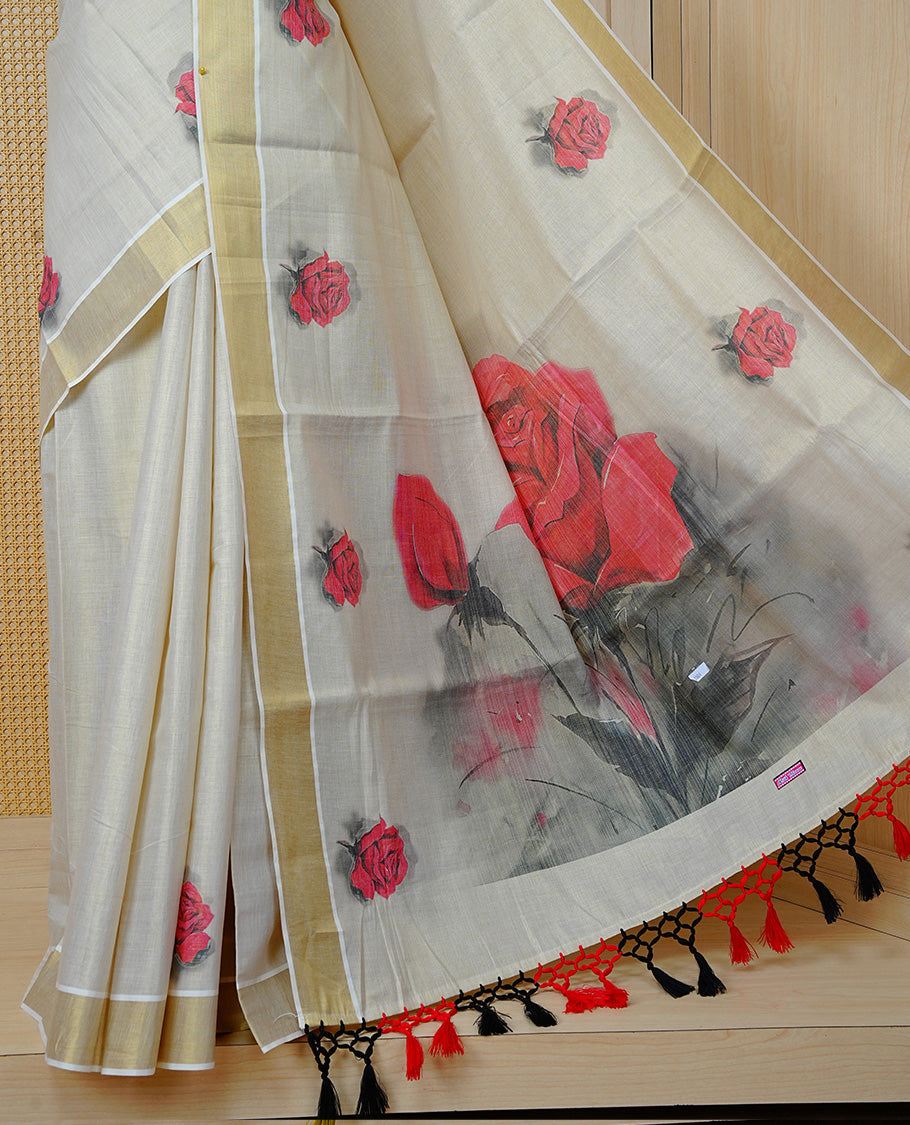 Cream Colour Tissue Kerala  Saree Featuring A Digital  Rose Printed Body &  Pallu ,  Beautifully Enhanced With A Classic Gold Zari Border And  Black & Red  Tassels, Paired With A Matching Blouse Piece.