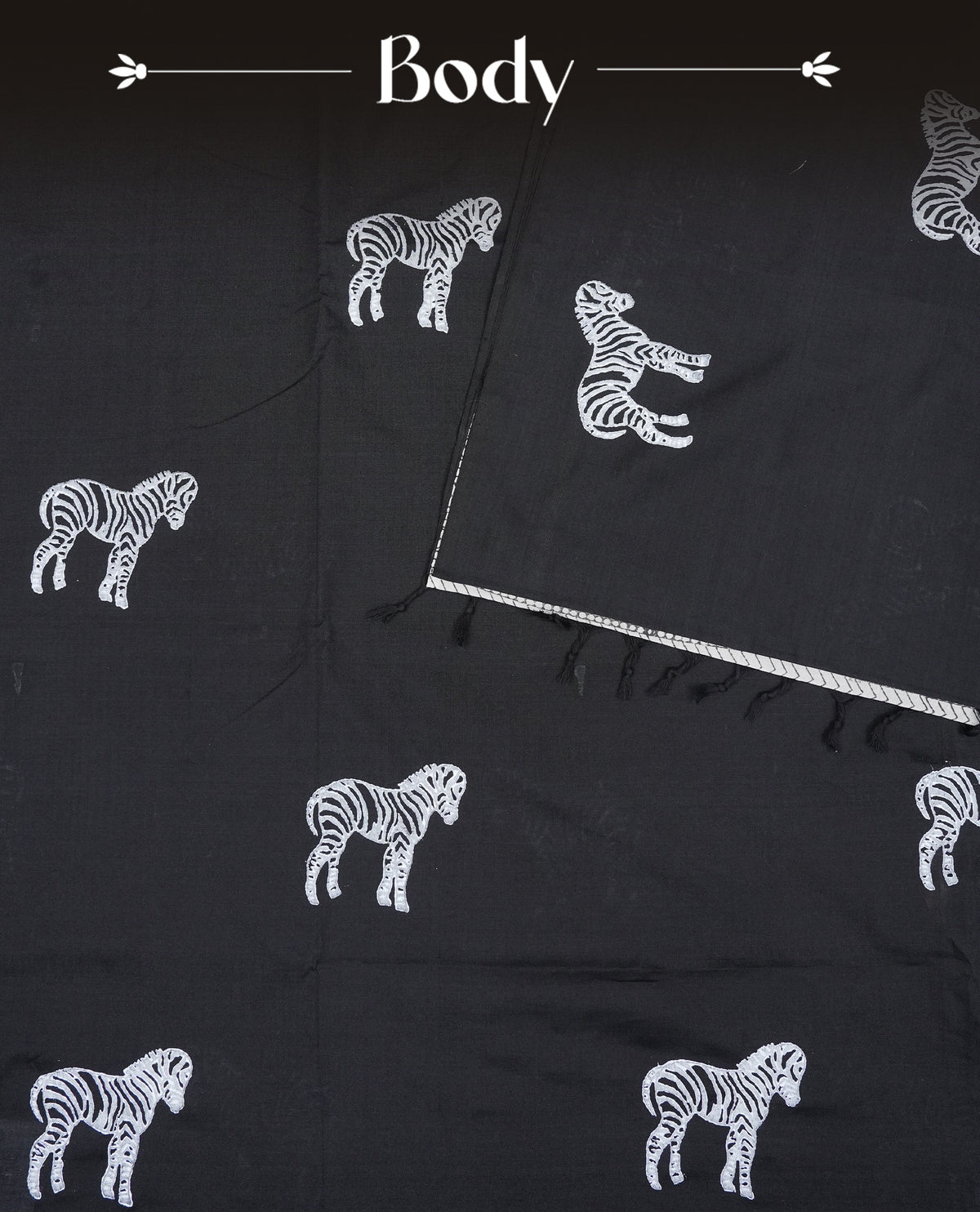 Black colour Polycotton Saree adorned with animal prints across the body and pallu, creating a graceful and minimalist look. Finished with a subtle black border and paired with a matching printed blouse piece,