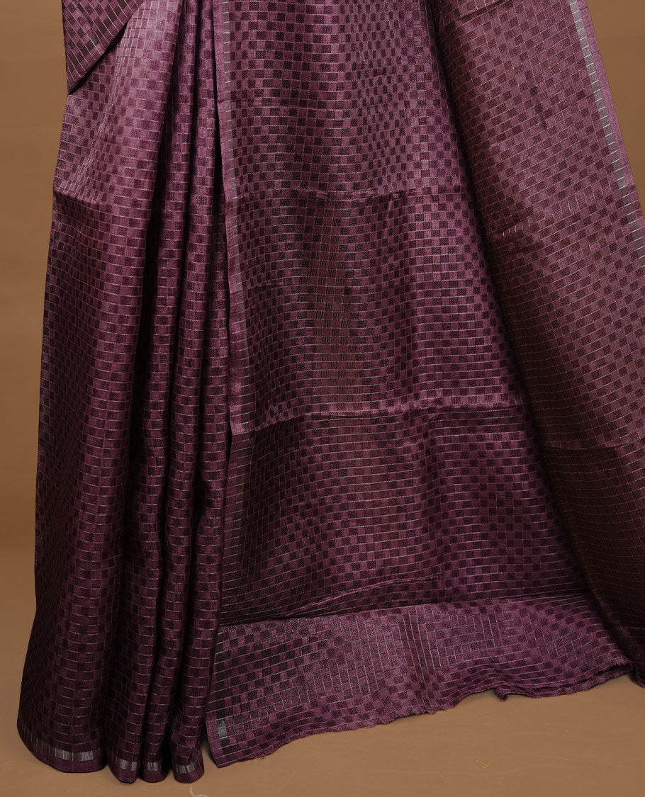 Onion colour Semi Tussar saree featuring an elegant zari fancy check pattern on the body, highlighted with a small border for a refined look. Comes without a blouse piece.