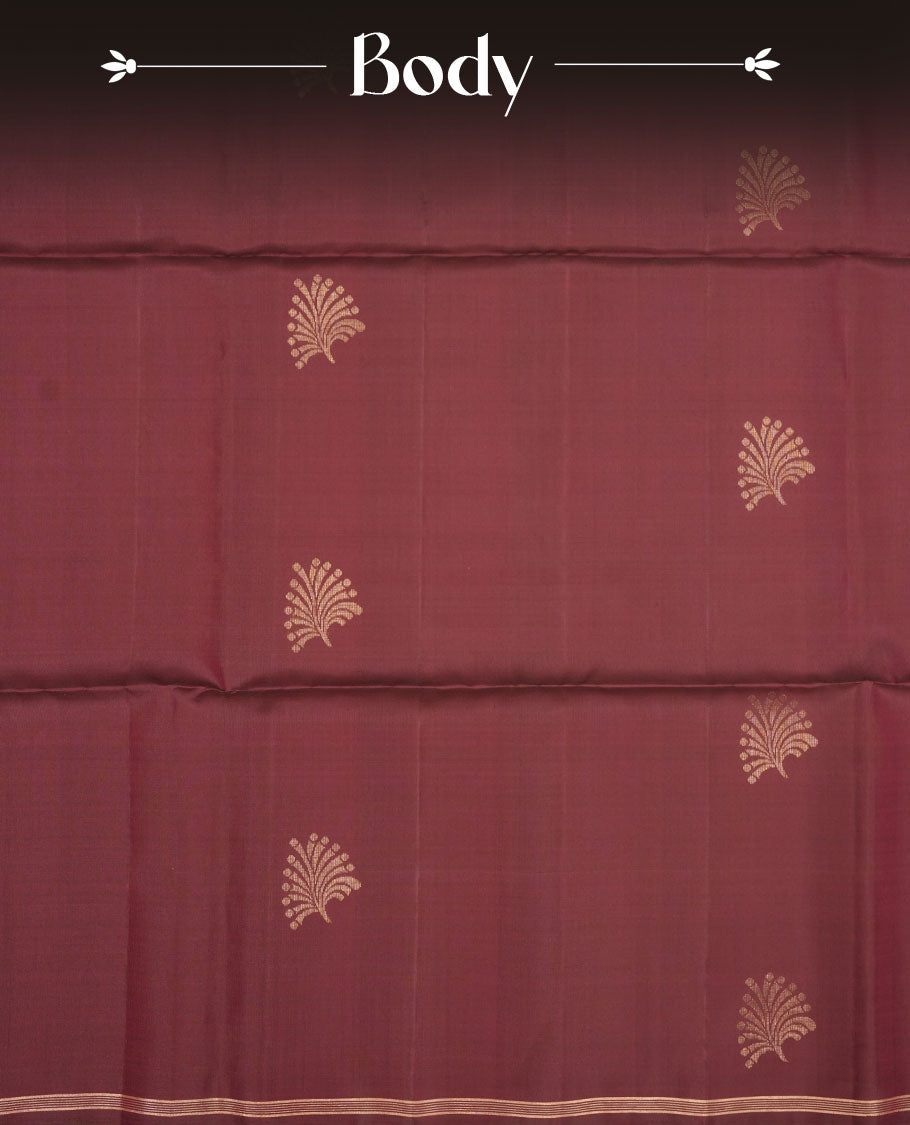 Brown colour soft silk saree featuring gold zari motifs on body, complemented by self colour with traditional border with tassel at pallu, paired with matching blouse piece.