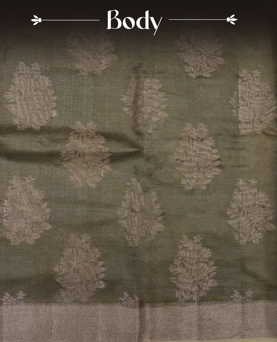 Dry olive colour pure banaras tusser silk saree highlighting antique zari pattern across body, with contrast cream colour with zari border and paired with matching blouse