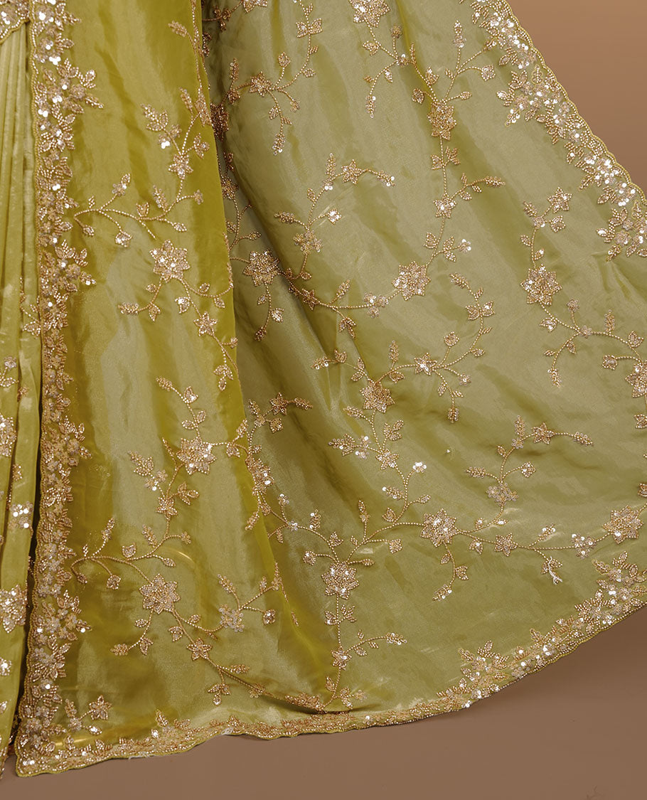 Olive colour net organza saree featuring cut beats and sequins floral kodi pattern on body, enhanced with worked border and cut beats work on blouse piece.