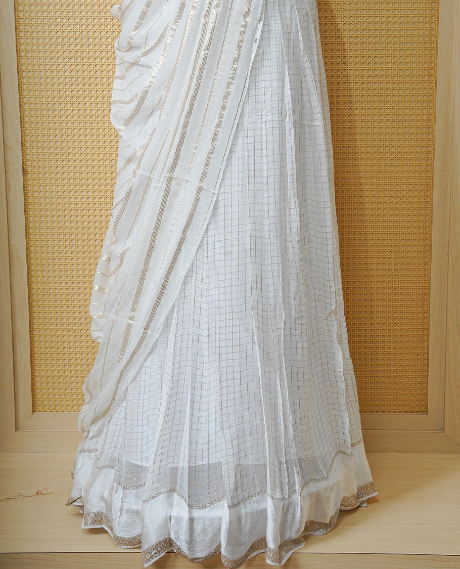 Off white colour Semi stitched dhavani set featuring Gold zari check pattern with Self colour border skirt, paired with matching blouse & dupatta.