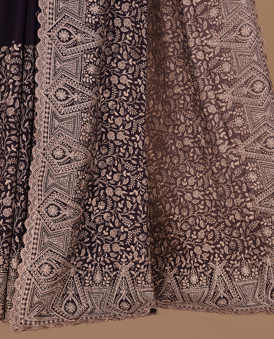 Maroon colour georgette designer saree featuring Gold thread floral pattern on body highlighting with stone and scalp border, paired with matching blouse piece.