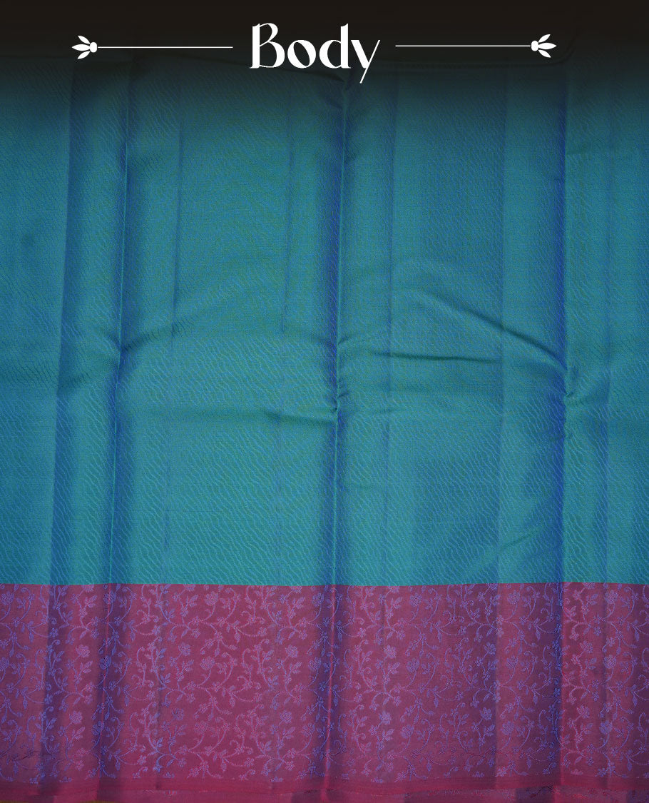 Peacock blue colour soft silk saree featuring zari pattern on body, complemented by a contrast purple zari patterned body, paired with matching blouse piece.