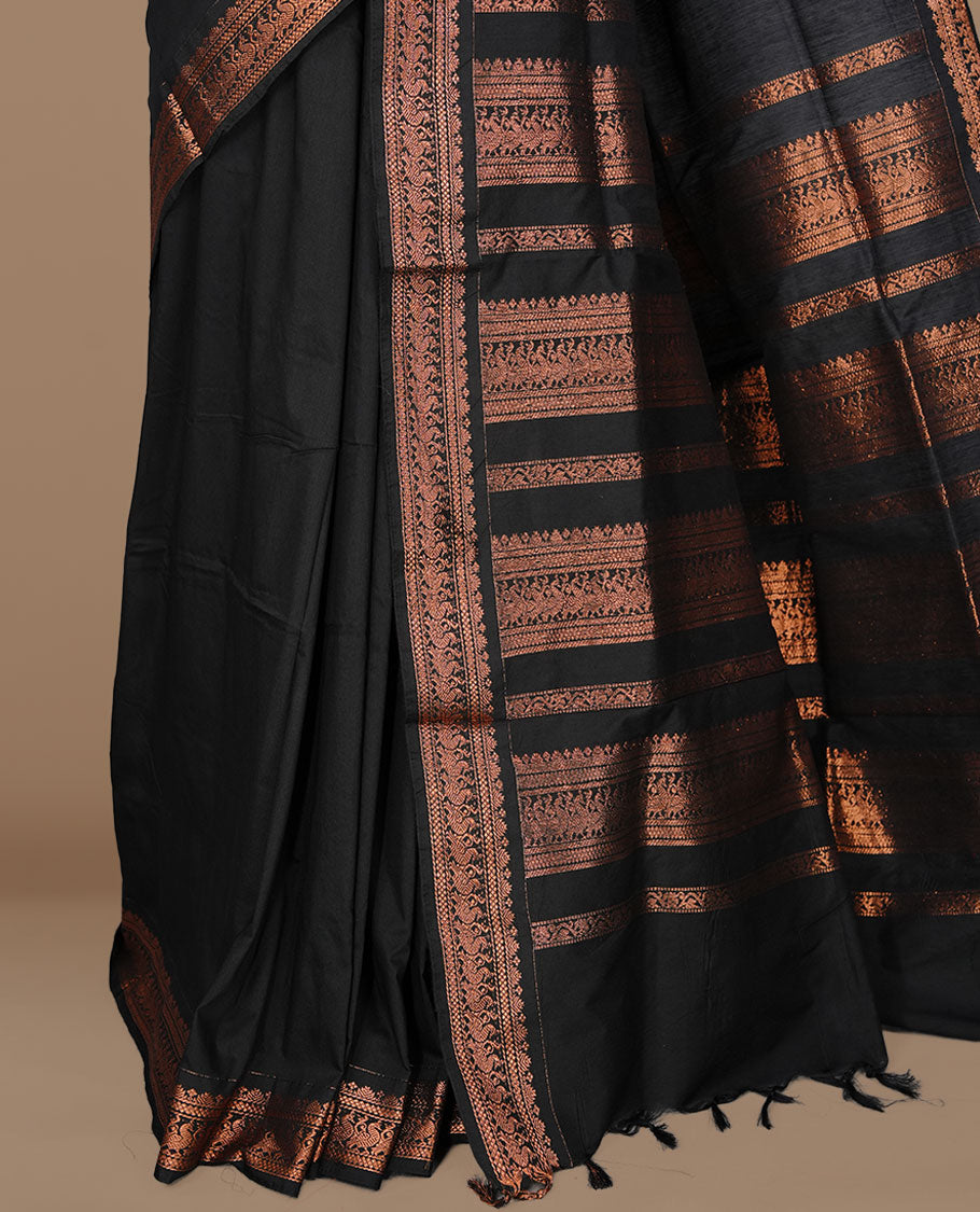 Black colour kalyani cotton saree featuring Elegant plain body, complemented by selfcolour with Antique zari border, paired with matching blouse piece.
