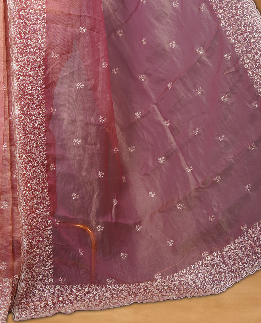 Pastel Pink colour net organza saree featuring white thread embroidery motifs on body and  thread detailing on the border and paired matching blouse.