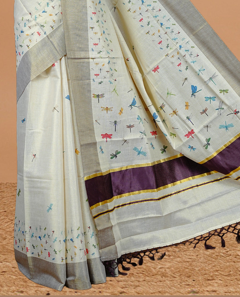 Cream Colour Tissue Kerala Saree Featuring  Plain Body ,Complemented By Maroon Zari With Dragonfly Printed   Border ,Enhance By A Maroon With Gold Zari  Pallu ,Paired With A Matching Blouse Piece.