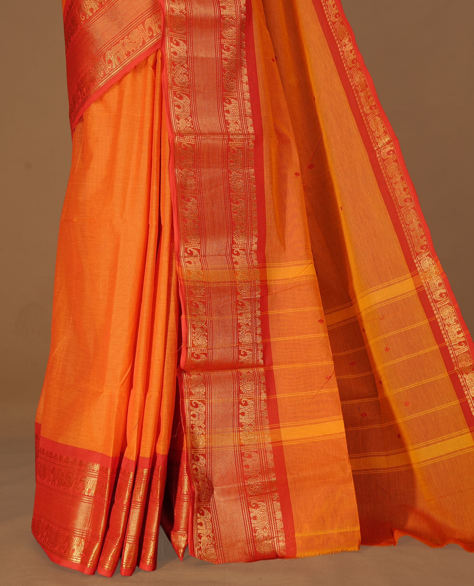 Orange Colour Chettinad cotton saree featuring Red motifs body , complemented by contrast Red colour with traditional border, comes with matching blouse piece.