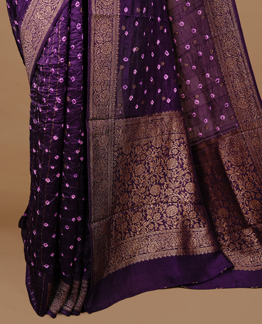 Purple colour Banarasi Bandhani silk saree featuring intricate antique zari circle Buttas across the body, complemented by an elegant antique zari border. Comes paired with a matching blouse piece