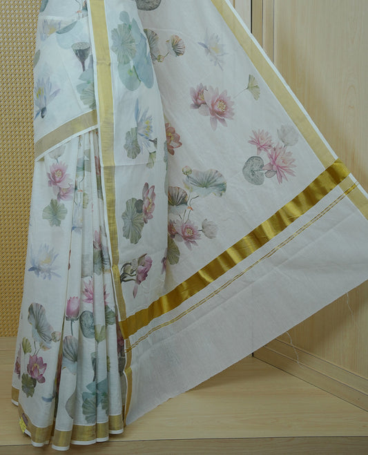 Cream colour Cotton kerala Saree featuring Lotus Print on body, Enhancing Gold zari kasavu border, comes with matching blouse piece.