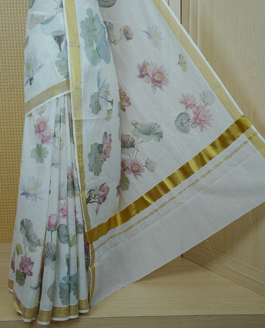 Cream colour Cotton kerala Saree featuring Lotus Print on body, Enhancing Gold zari kasavu border, comes with matching blouse piece.