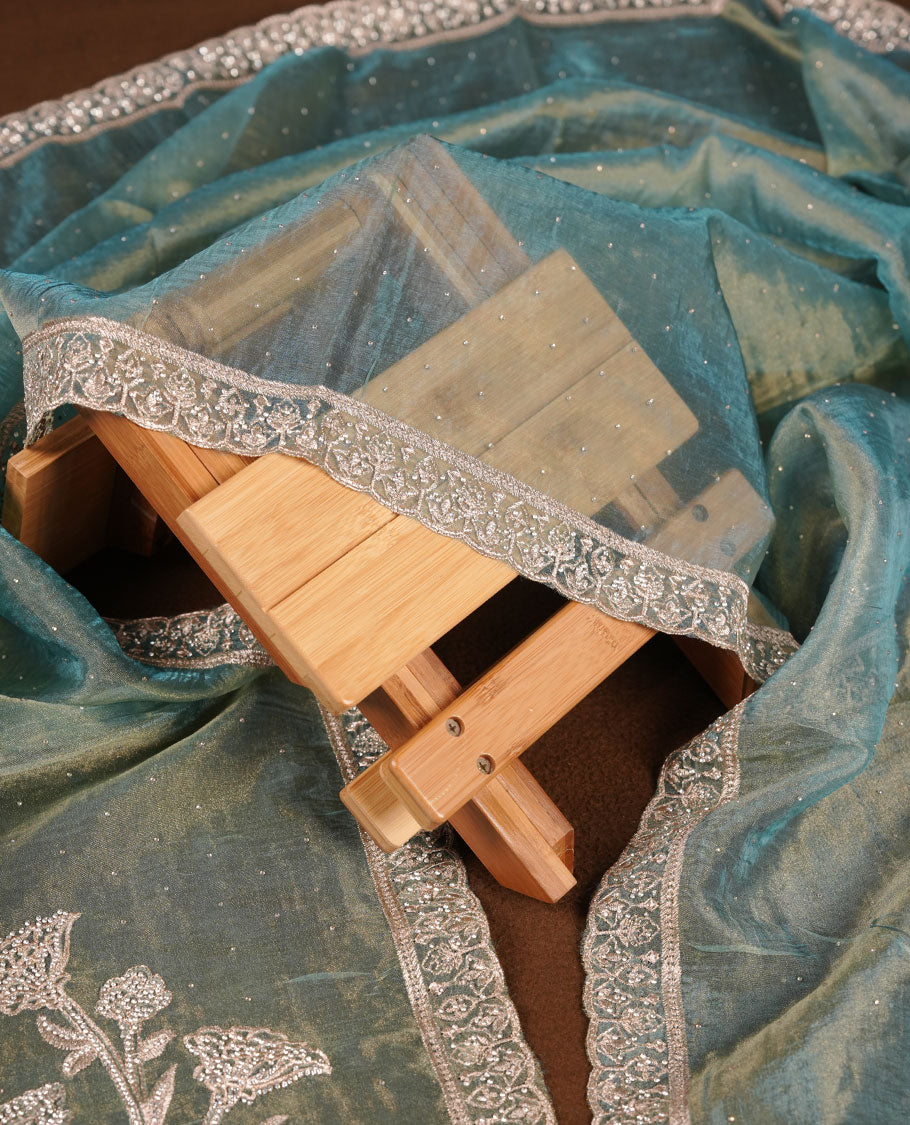 Powder blue colour churidar set with stone and thread embroidery and detailing, paired with matching pant and dupatta.